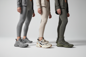 Three athletic women standing side by side in a dynamic pose, wearing premium modern sports shoes, focus on footwear details, diverse models with confident expressions, stylish athletic outfits in neutral tones, studio lighting with soft shadows, clean minimal background, luxury sportswear brand aesthetic, high fashion commercial photography, ultra-realistic, sharp focus, shallow depth of field, cinematic lighting, 8k quality --ar 16:9 --v 6 --style raw
